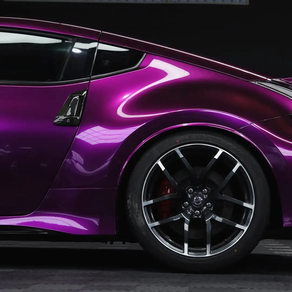 Left rear corner of a Nissan Z wrapped in Audi Pearl Grape gloss metallic vinyl - Kaleido