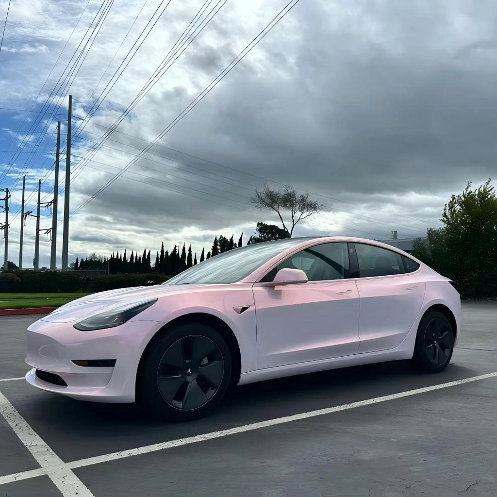 Blossom Whisper color shift vinyl wrap on a Tesla Model 3, front-left view showcasing the elegant pink to white transition on the car's sleek profile - Kaleido