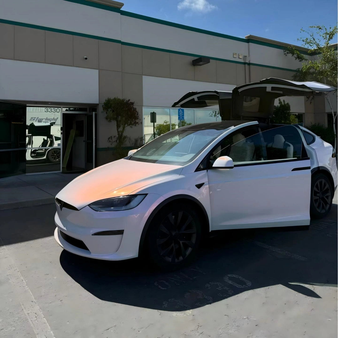 Tesla Model X in Blossom Whisper color shift wrap - front-left view showing elegant pink-white shift on Falcon Wing doors - Kaleido