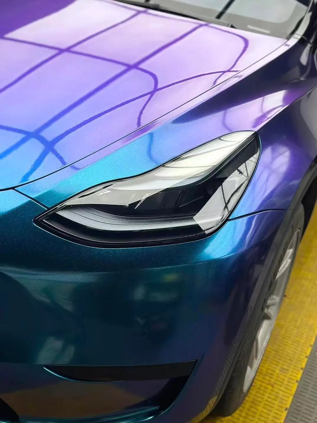 Detailed shot of Diamond Purple Blue wrap on Tesla Model Y front-left corner - Kaleido