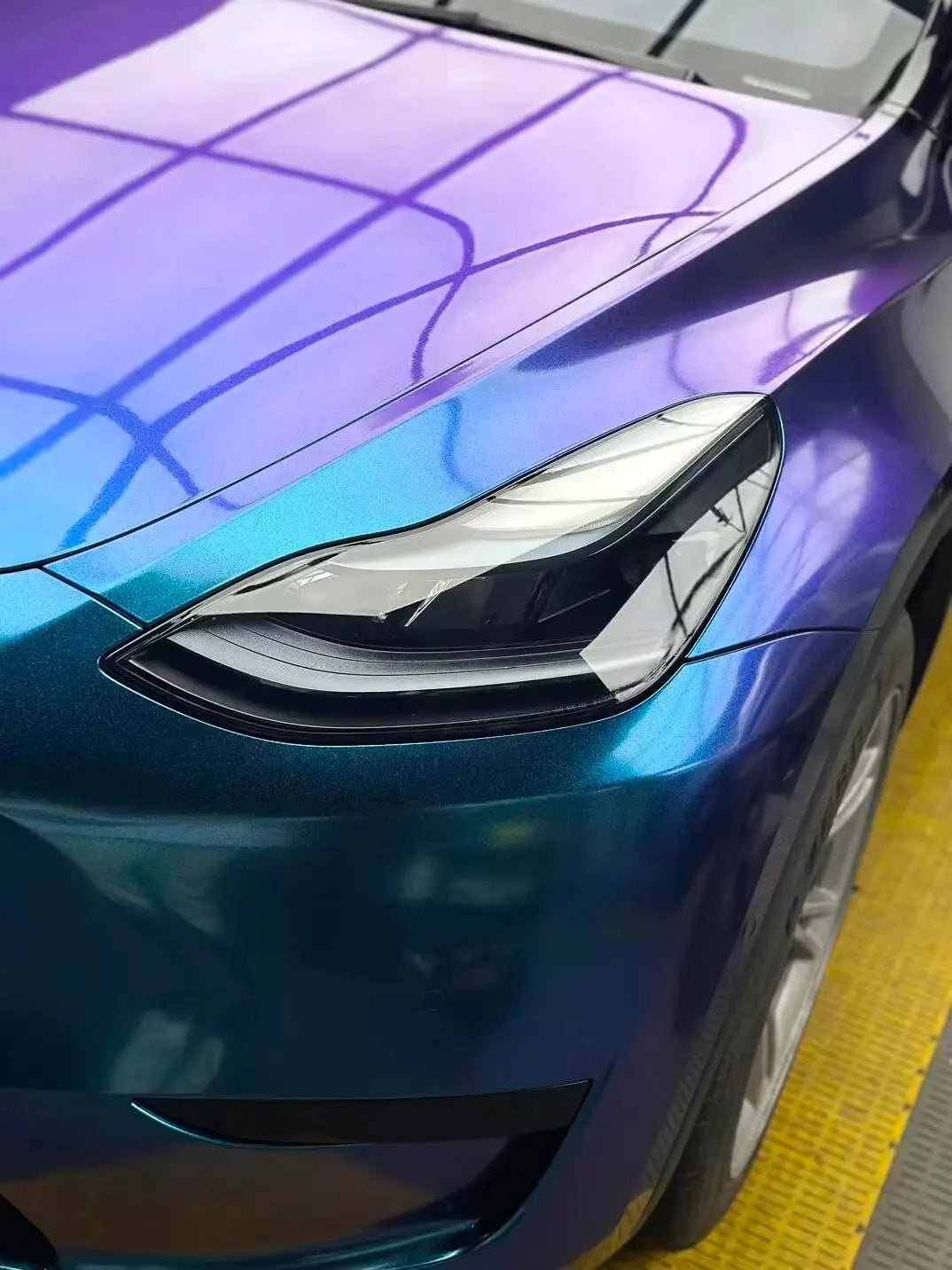 Detailed shot of Diamond Purple Blue wrap on Tesla Model Y front-left corner - Kaleido