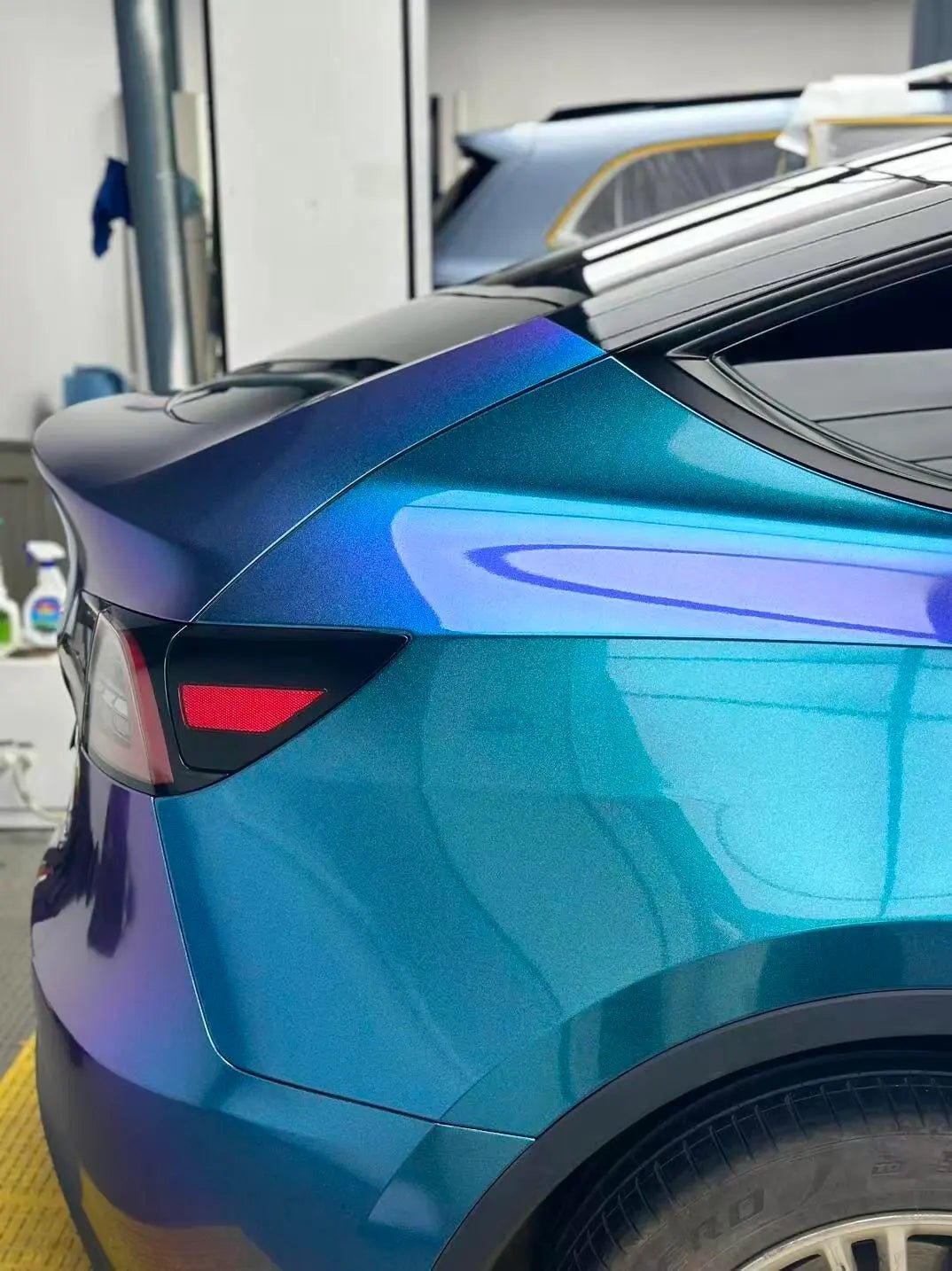 Diamond Purple Blue color shift wrap on Tesla Model Y right rear quarter panel - Kaleido