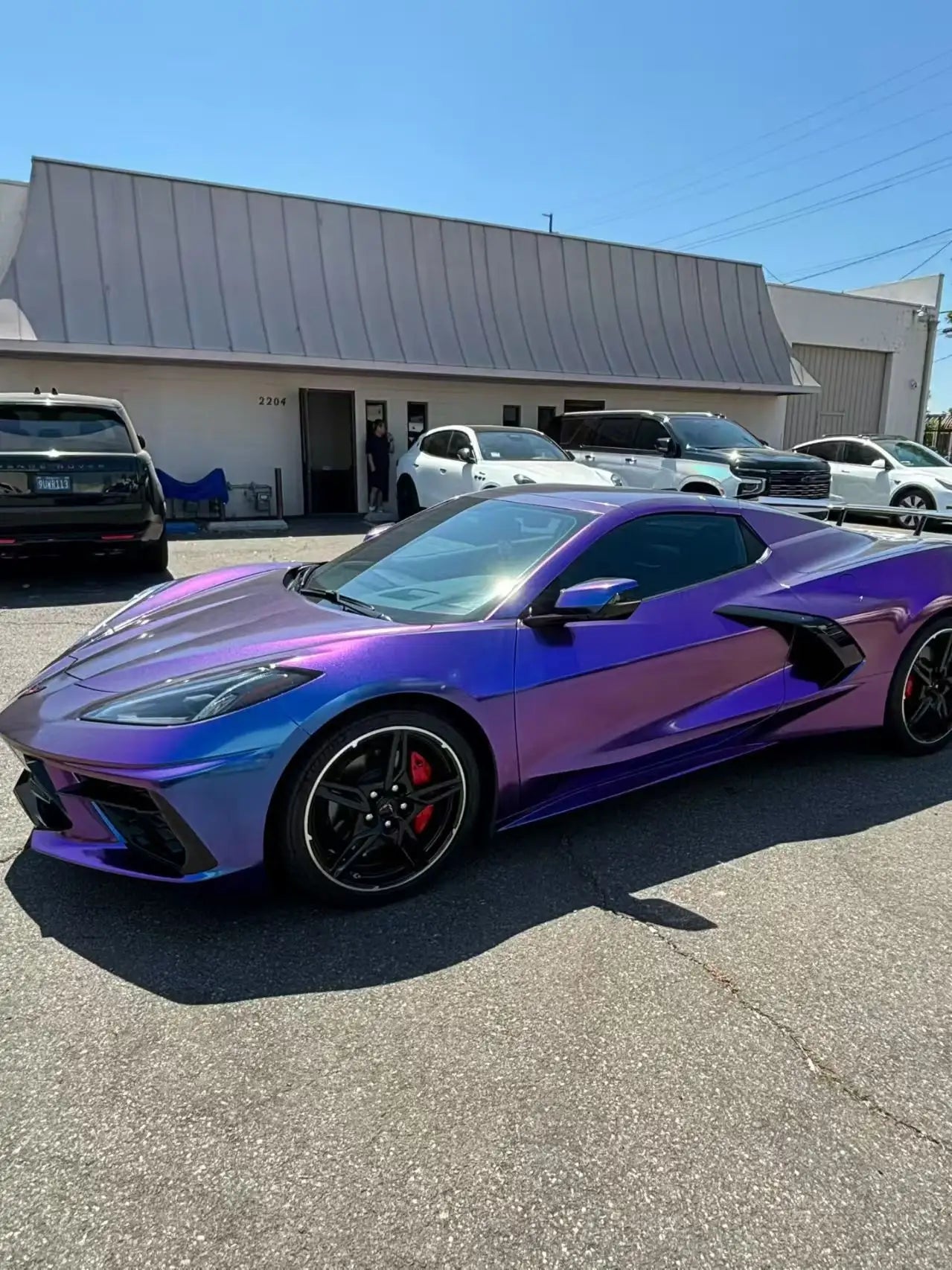 Chevrolet Corvette C8 in Diamond Purple Red color shift wrap - front-left view of the mid-engine sports car - Kaleido