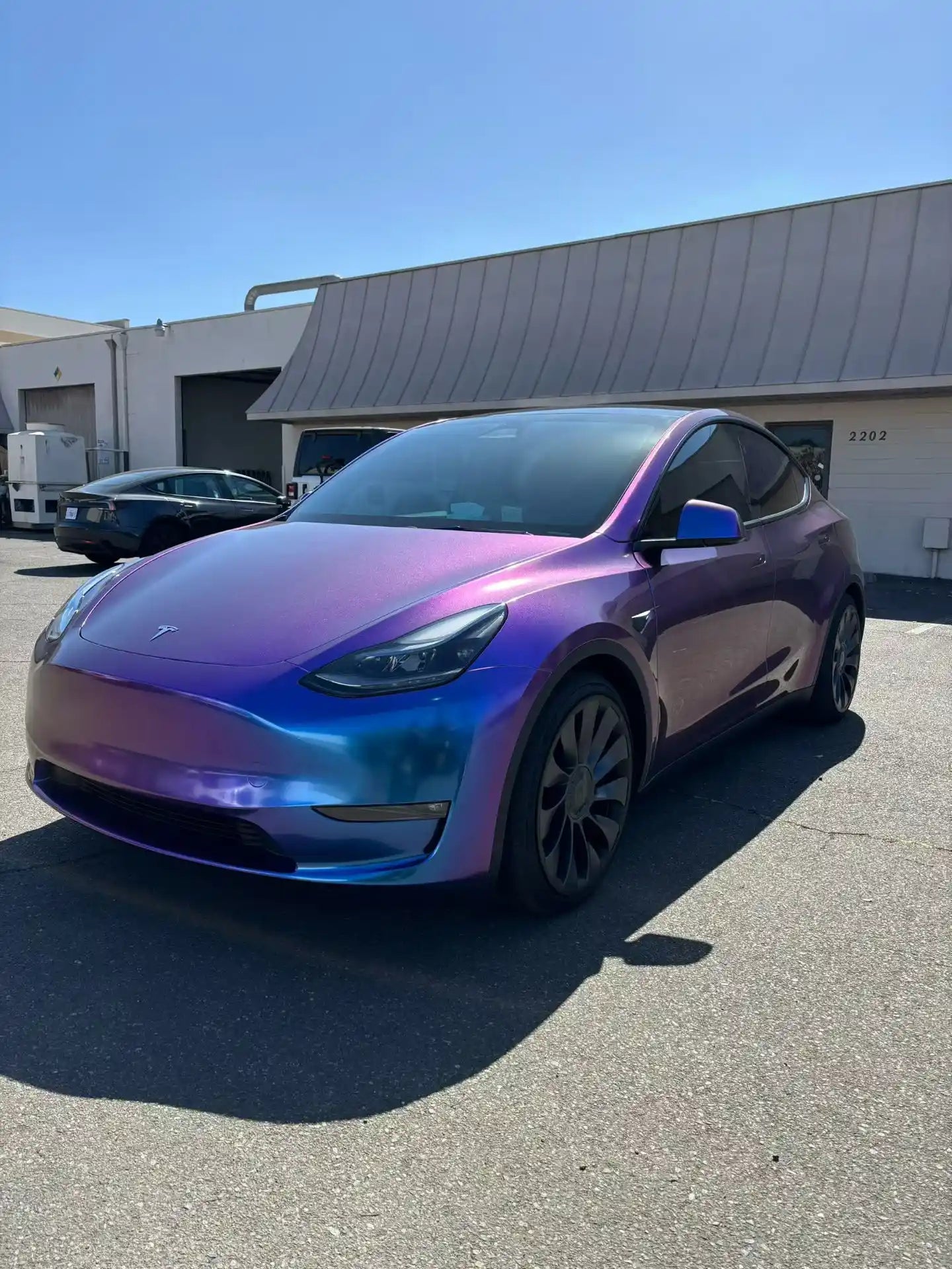 Front-left view of Tesla Model Y wrapped in Diamond Purple Red color shift film - Kaleido