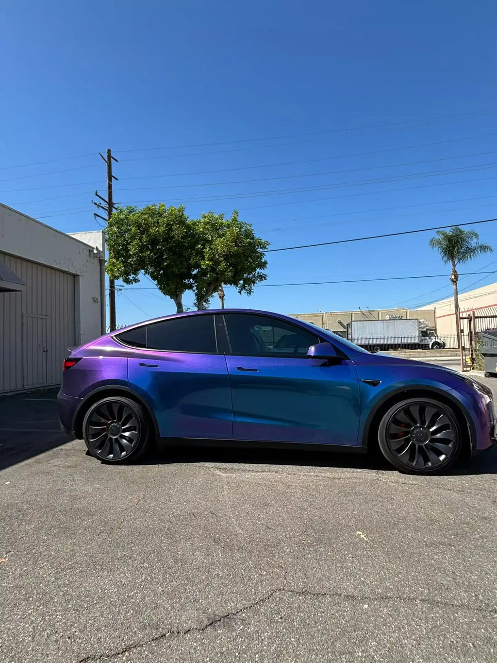 Right side view of Tesla Model Y in Diamond Purple Red color shift vinyl - Kaleido