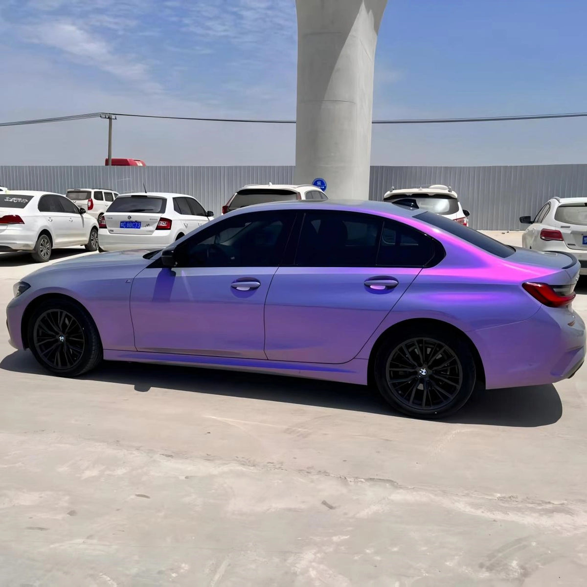 Lifestyle shot of Mystic Violet BMW 1 Series in urban setting - color shift from grey to purple - Kaleido
