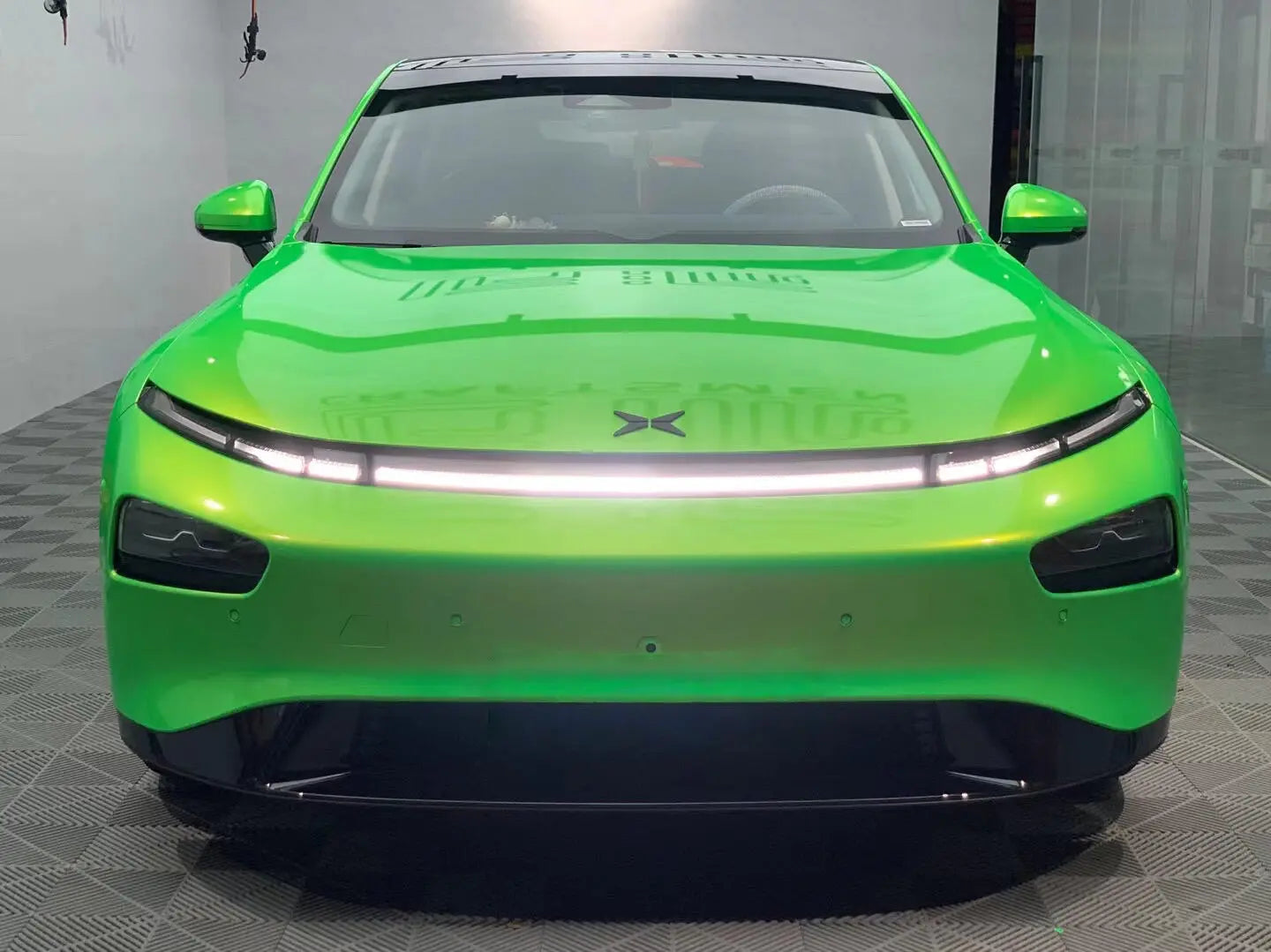 Front view of Neon Gold Green color shift wrapped Xpeng P7 - electric sedan styling - Kaleido