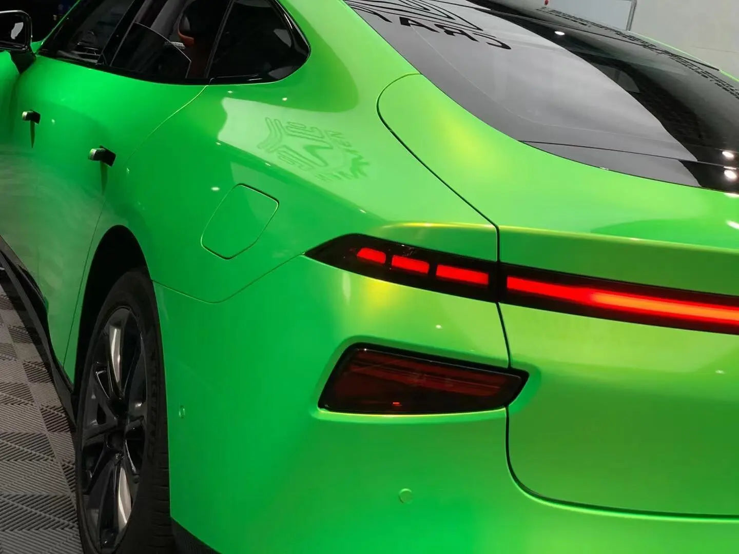 Xpeng P7 with Neon Gold Green wrap - rear-left view highlighting fastback design - Kaleido