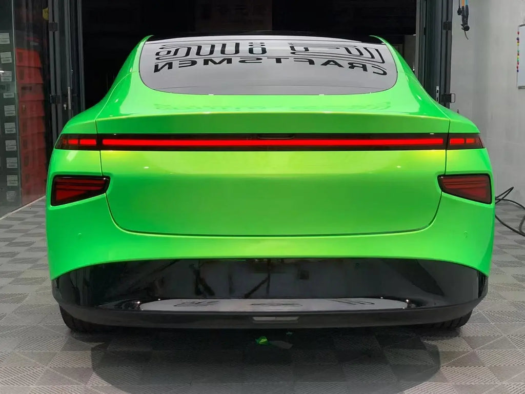 Rear view of Xpeng P7 in Neon Gold Green color shift vinyl - full width light bar - Kaleido