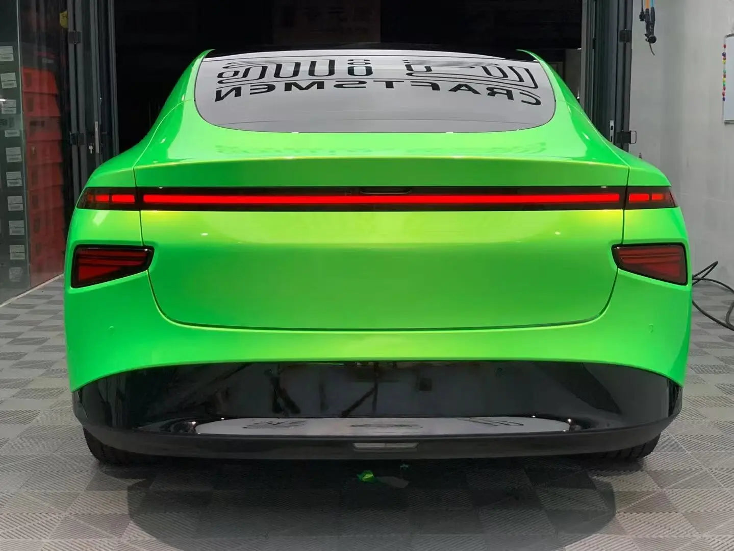 Rear view of Xpeng P7 in Neon Gold Green color shift vinyl - full width light bar - Kaleido