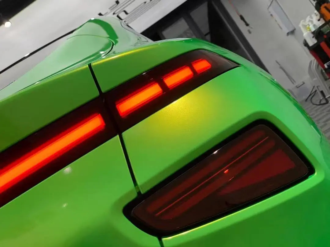 Detailed view of Neon Gold Green vinyl on Xpeng P7 taillight area - seamless installation - Kaleido