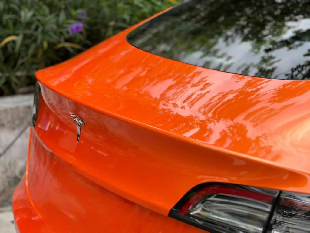 Neon Gold Orange vinyl on Tesla Model 3 trunk lid - smooth finish on rear panel - Kaleido