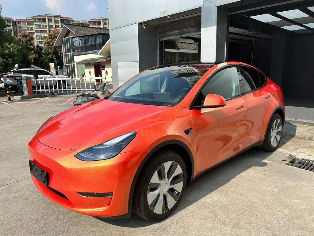 Front-left view of Neon Gold Orange wrapped Tesla Model Y - SUV styling with color shift - Kaleido