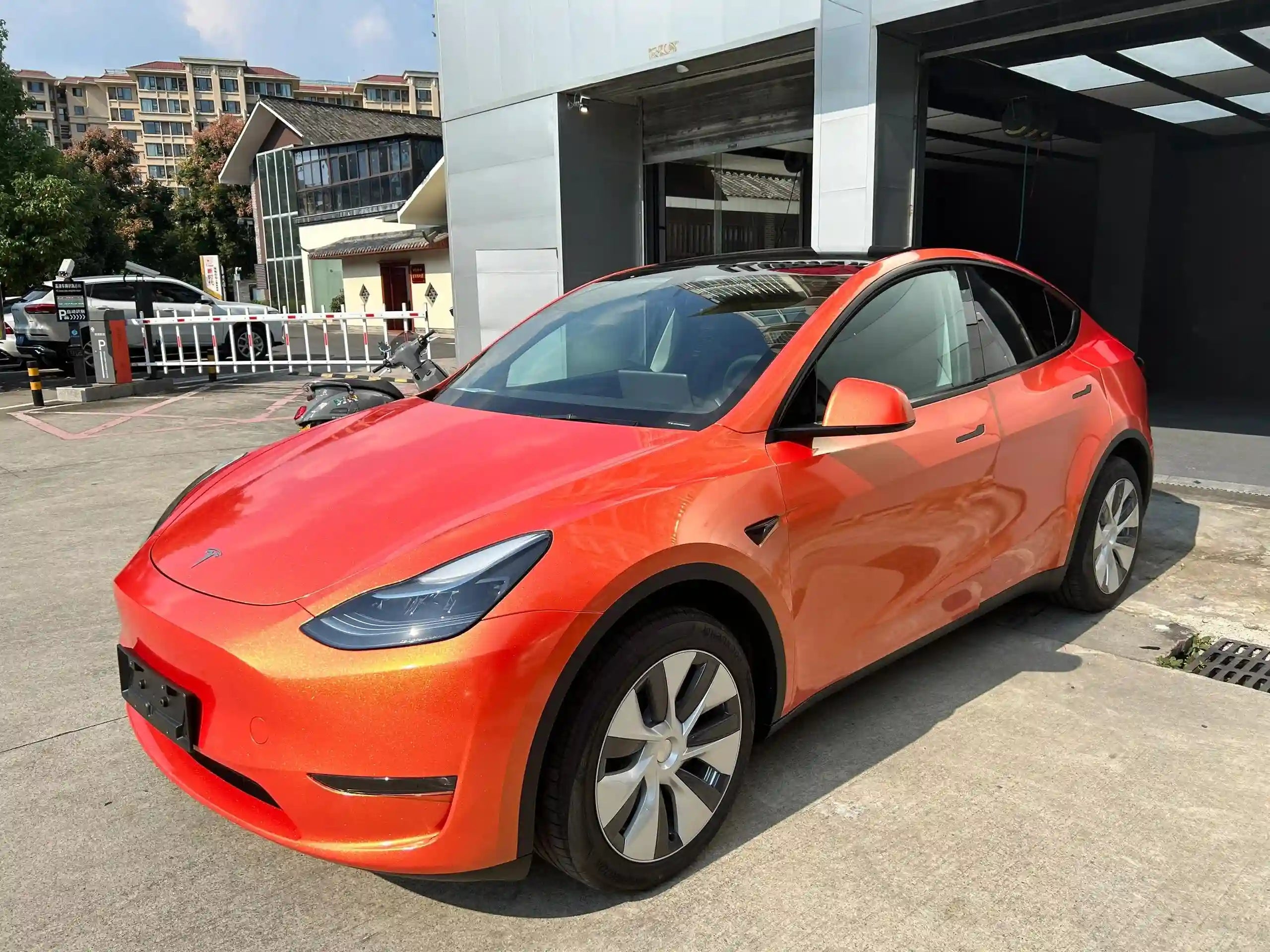 Front-left view of Neon Gold Orange wrapped Tesla Model Y - SUV styling with color shift - Kaleido
