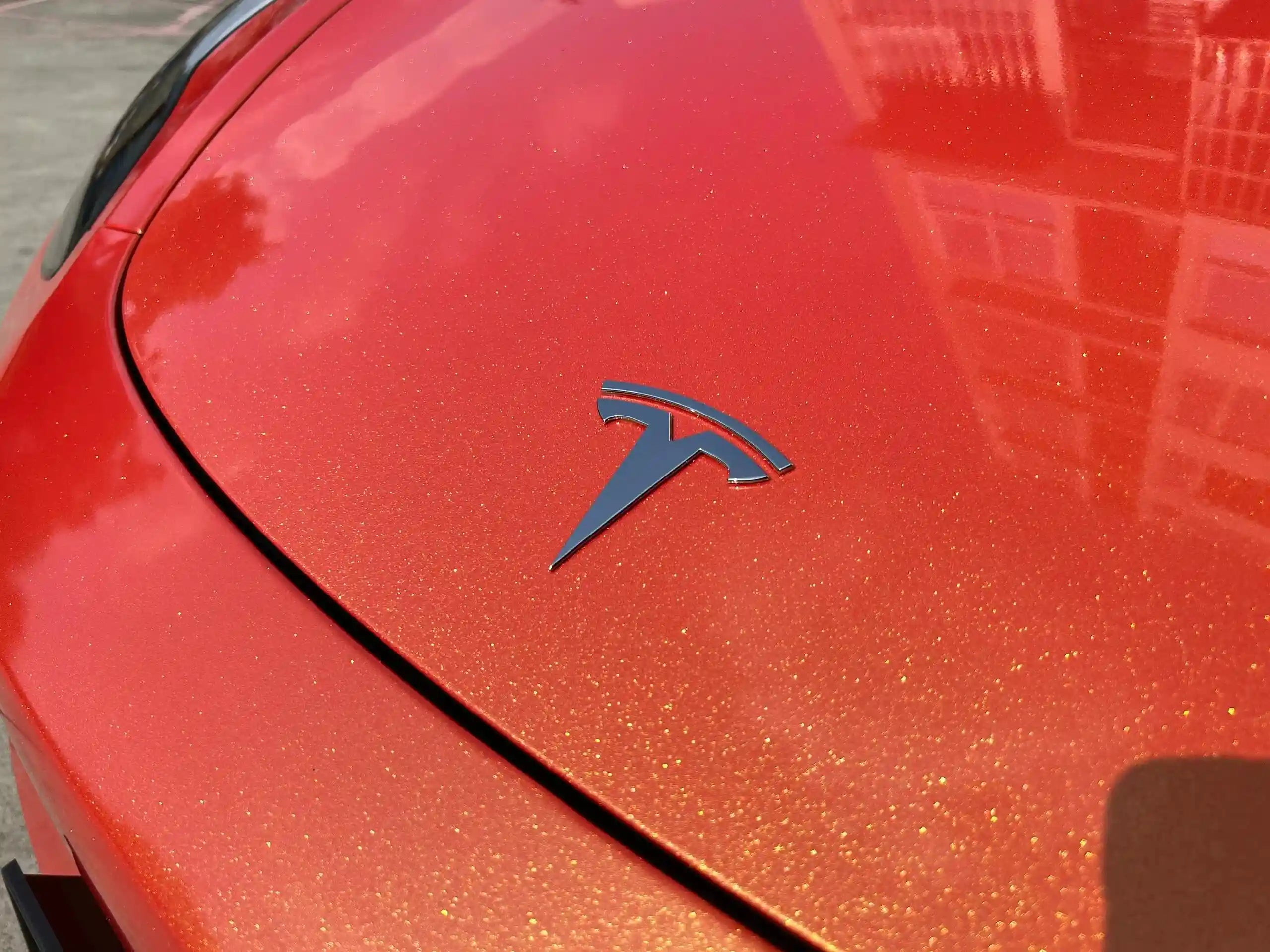 Neon Gold Orange color shift film on Tesla Model Y hood - dramatic gold to orange transformation - Kaleido