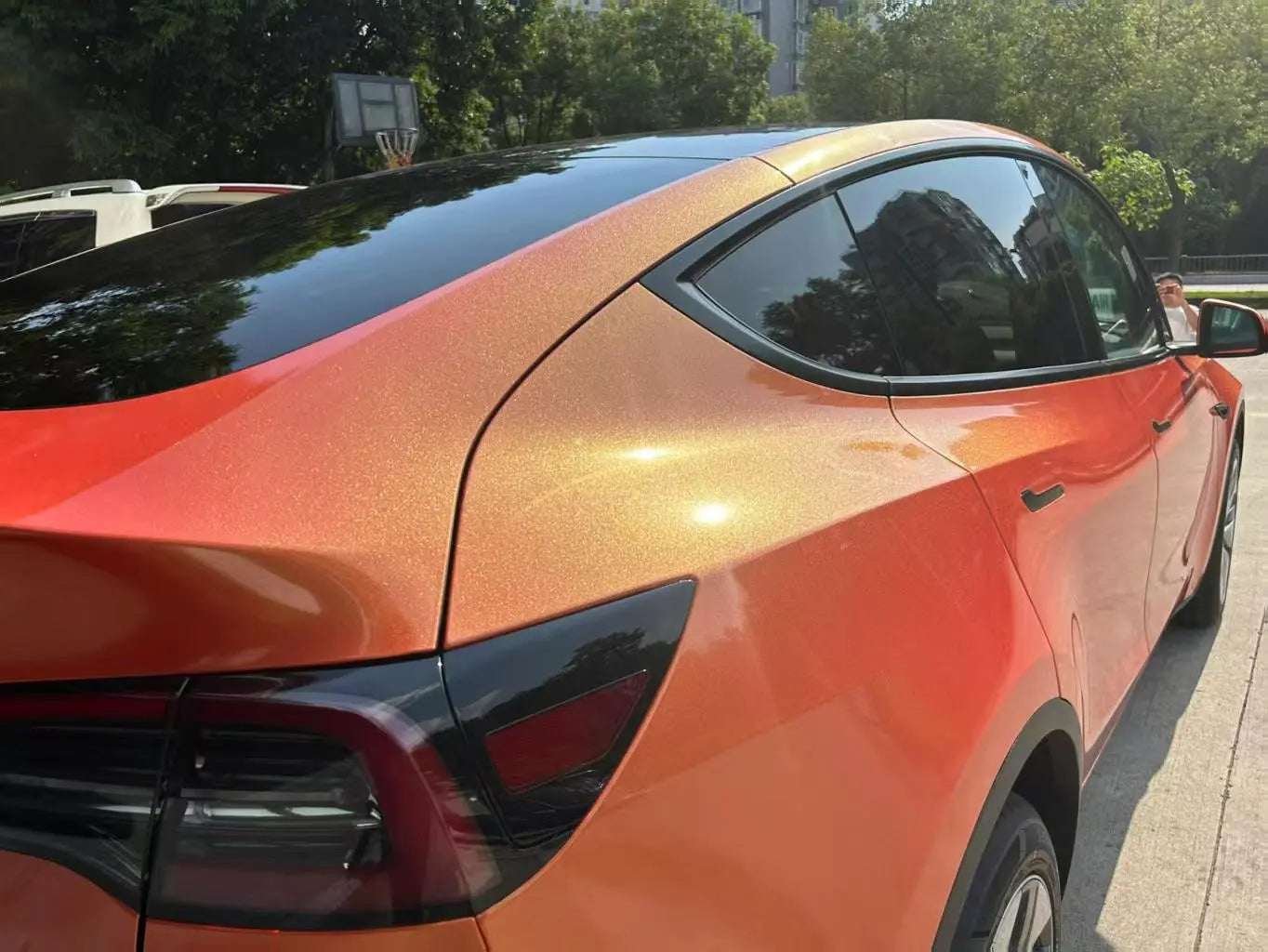 Neon Gold Orange wrap on Tesla Model Y rear-right - detailed color shift effect - Kaleido