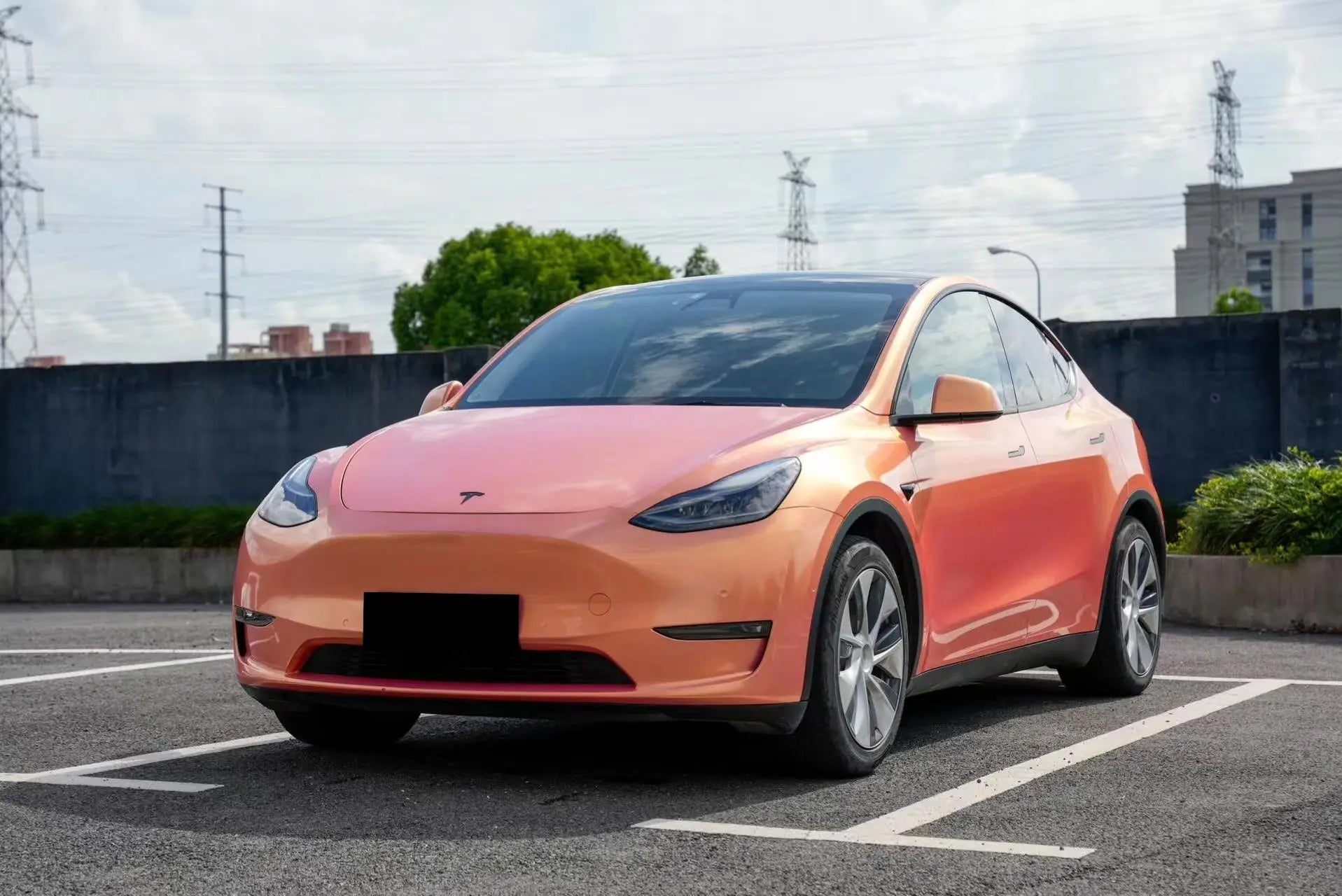 Wide front-left view of Neon Gold Pink wrapped Tesla Model Y - full SUV profile - Kaleido