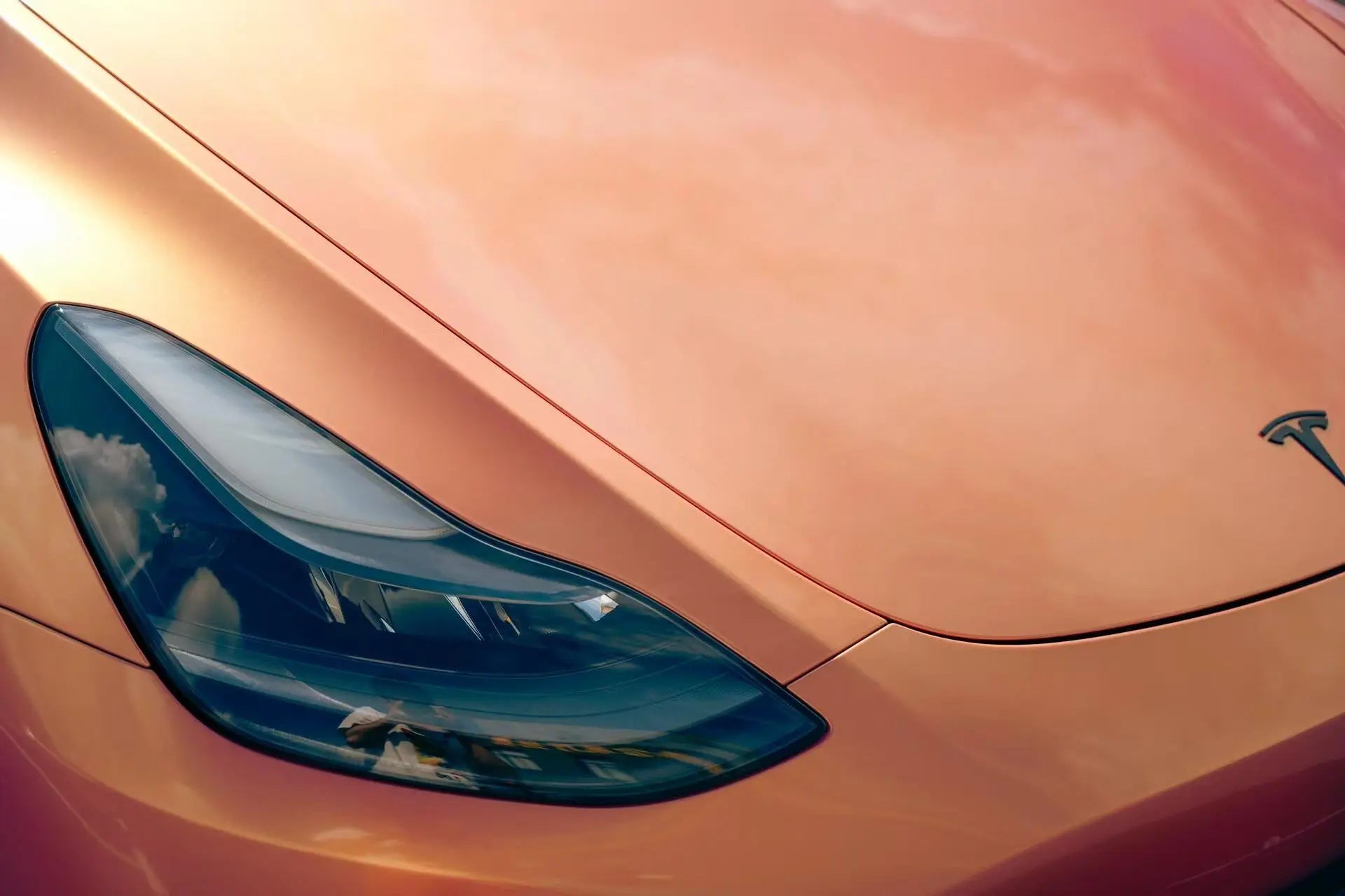 Neon Gold Pink color shift detail on Tesla Model Y front-right bumper - showcasing color transition effect - Kaleido