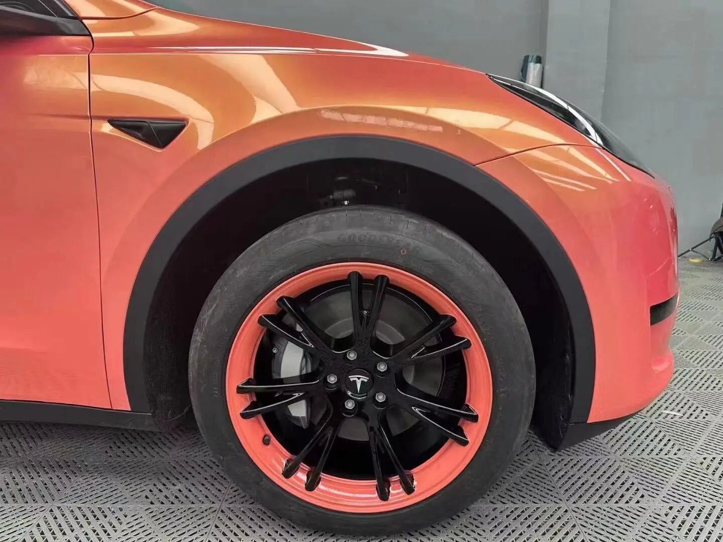 Close-up of Neon Gold Pink wrap on Tesla Model Y front-right corner - vibrant color shifting detail - Kaleido