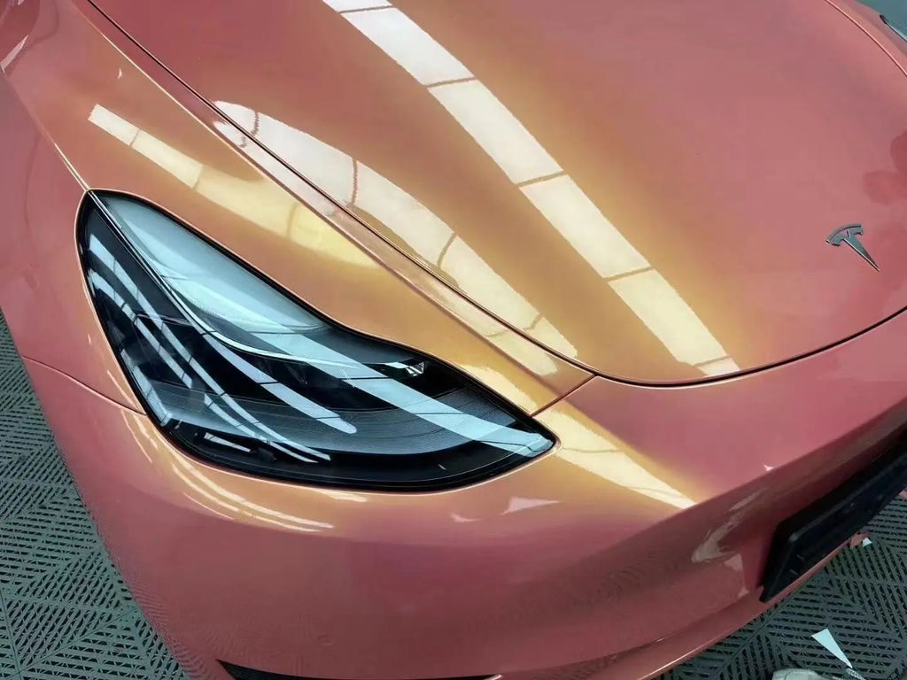 Close-up of Neon Gold Pink color shift on Tesla Model Y hood - dynamic color effect - Kaleido