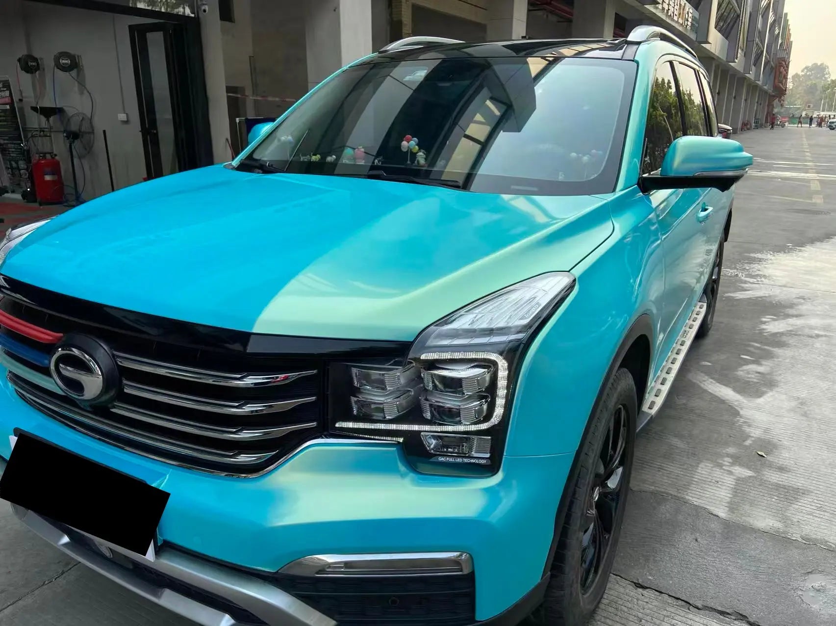 Neon Ice Blue color shift wrap on GAC Motor GS8 front-left - highlighting SUV proportions - Kaleido