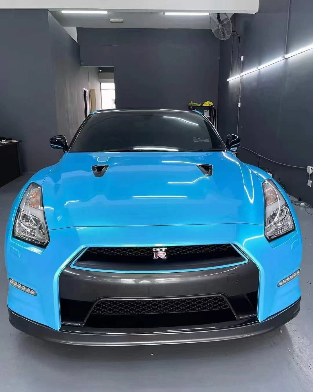 Full front view of Neon Sky Blue color shift wrapped Nissan GT-R - Godzilla presence - Kaleido