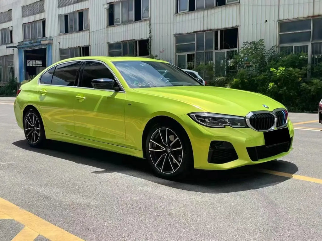 Front-right 45-degree view of Neon Yellow wrapped BMW 5 Series - full side profile - Kaleido