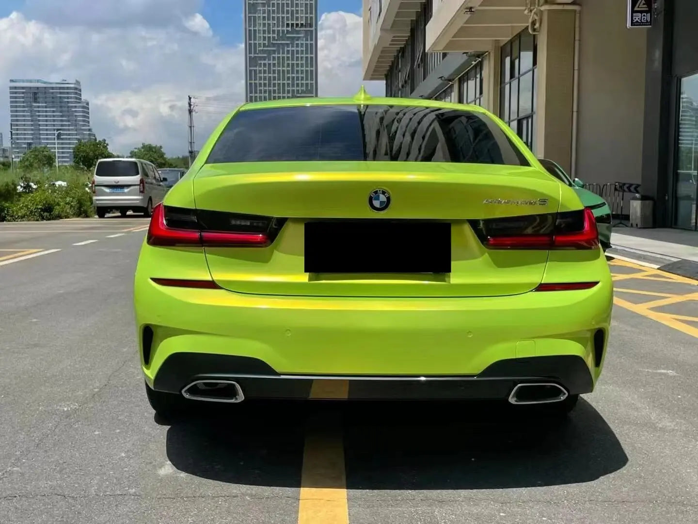 Rear view of BMW 5 Series in Neon Yellow color shift vinyl - Kaleido