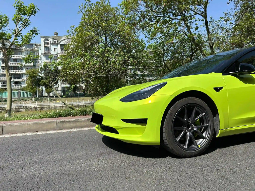 Close-up of Neon Yellow wrap on Tesla Model 3 front-left bumper - Kaleido