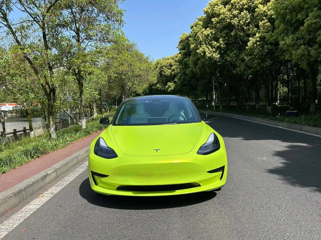 Tesla Model 3 in Neon Yellow Color Shift vinyl - front view showing vibrant fluorescent finish - Kaleido