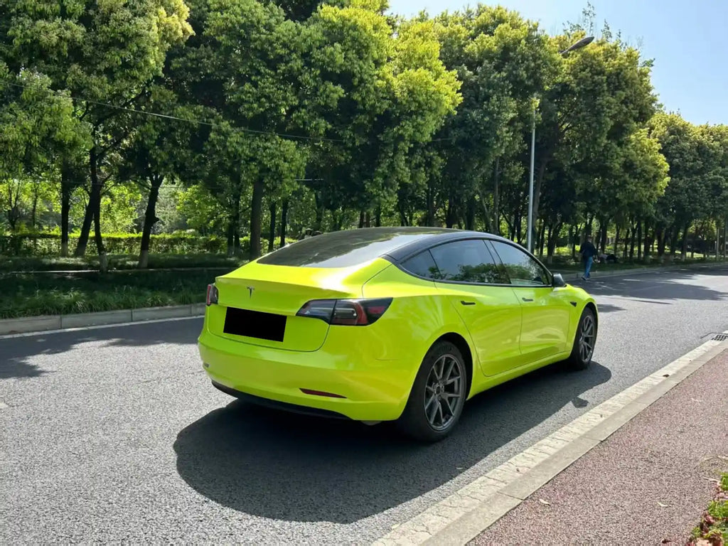 Neon Yellow color shift wrap on Tesla Model 3 rear-right quarter - Kaleido