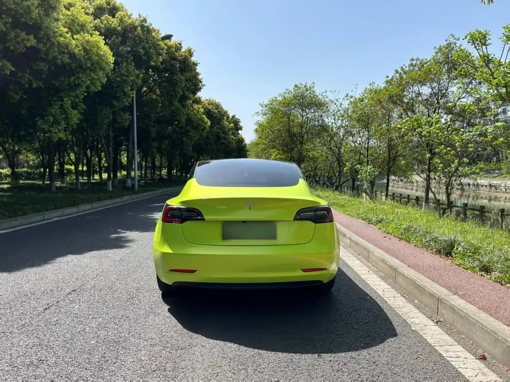 Rear view of Neon Yellow wrapped Tesla Model 3 - color shift effect on tailgate - Kaleido