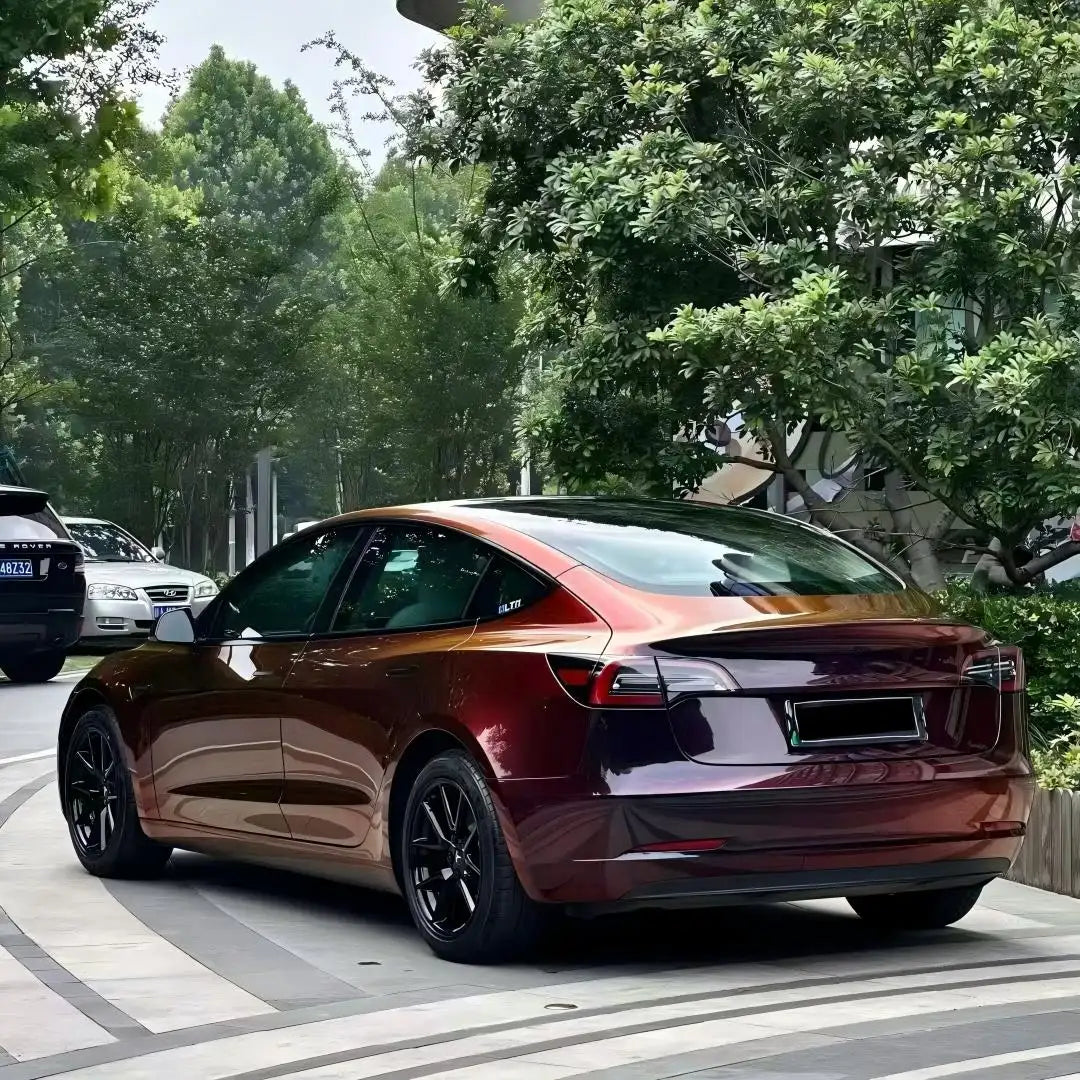Onyx Ignition vinyl wrap on Tesla Model 3 - rear-left view with black to red effect - Kaleido