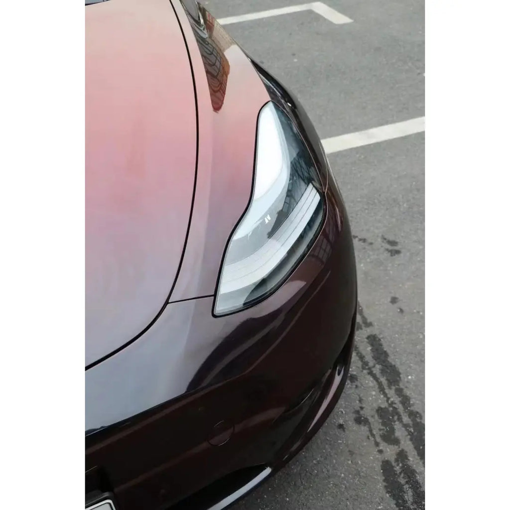 Macro shot of Onyx Ignition film on Model Y front bumper - black to red flakes - Kaleido