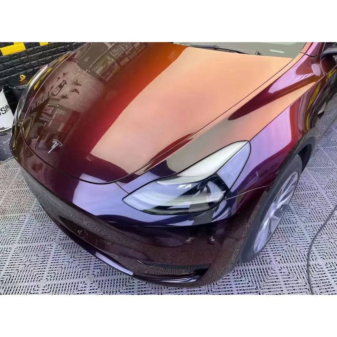 Close-up of Onyx Ignition wrap on Tesla Model Y front-left hood - color shift detail - Kaleido