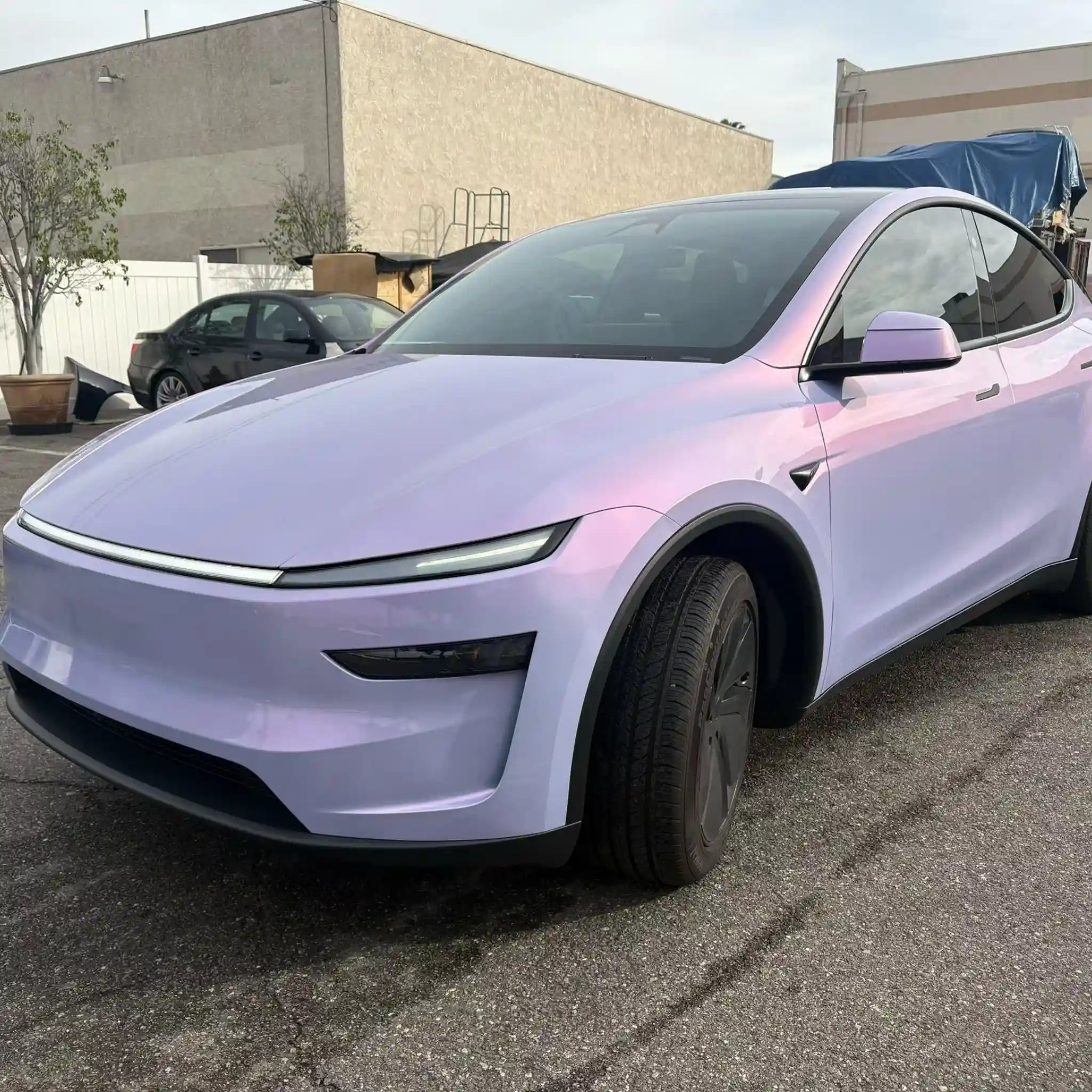 Front-left view of Tesla Model Y wrapped in Color Shift Pearl Blue Pink - Kaleido