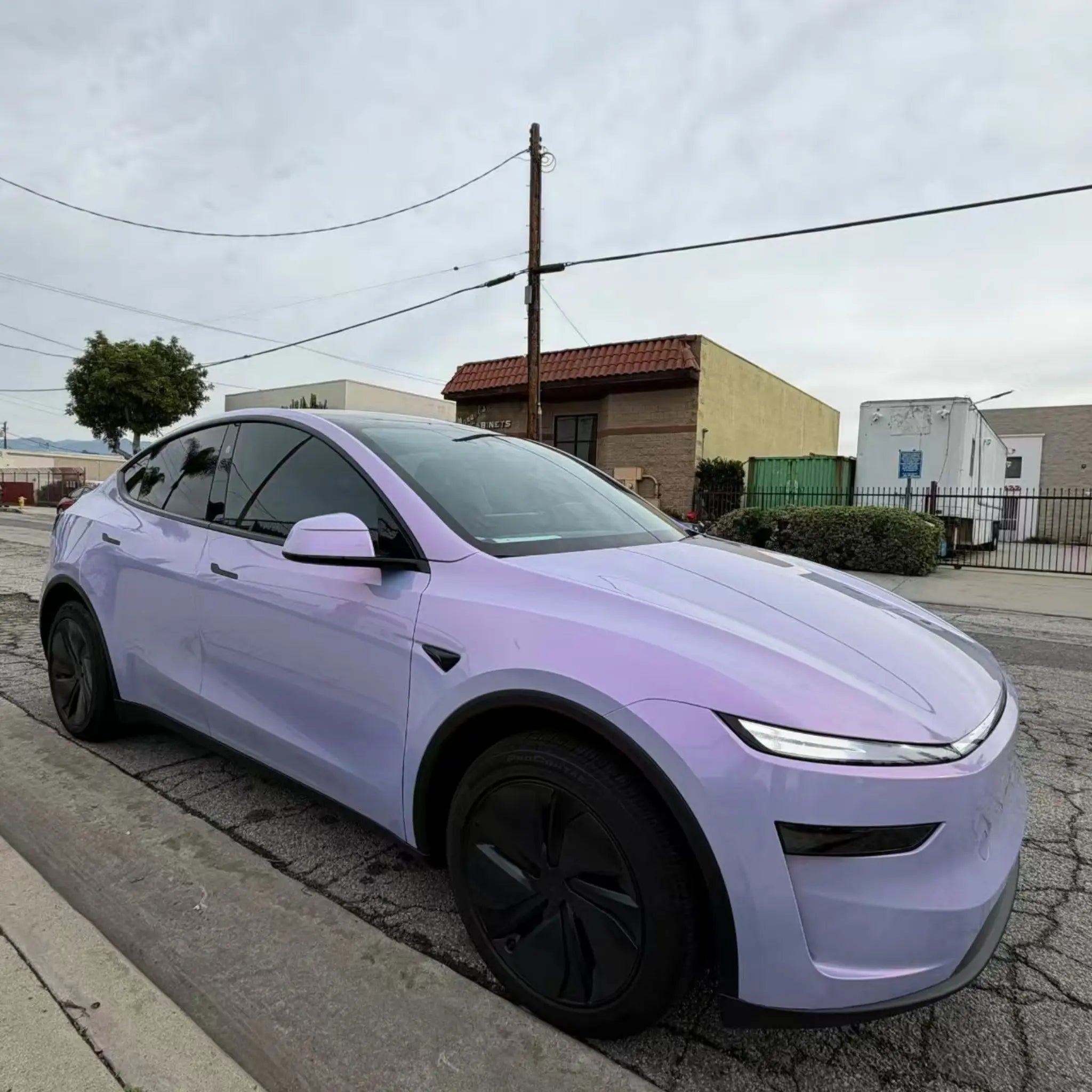 Tesla Model Y in Color Shift Pearl Blue Pink wrap - front-right view showing blue to pink transition - Kaleido
