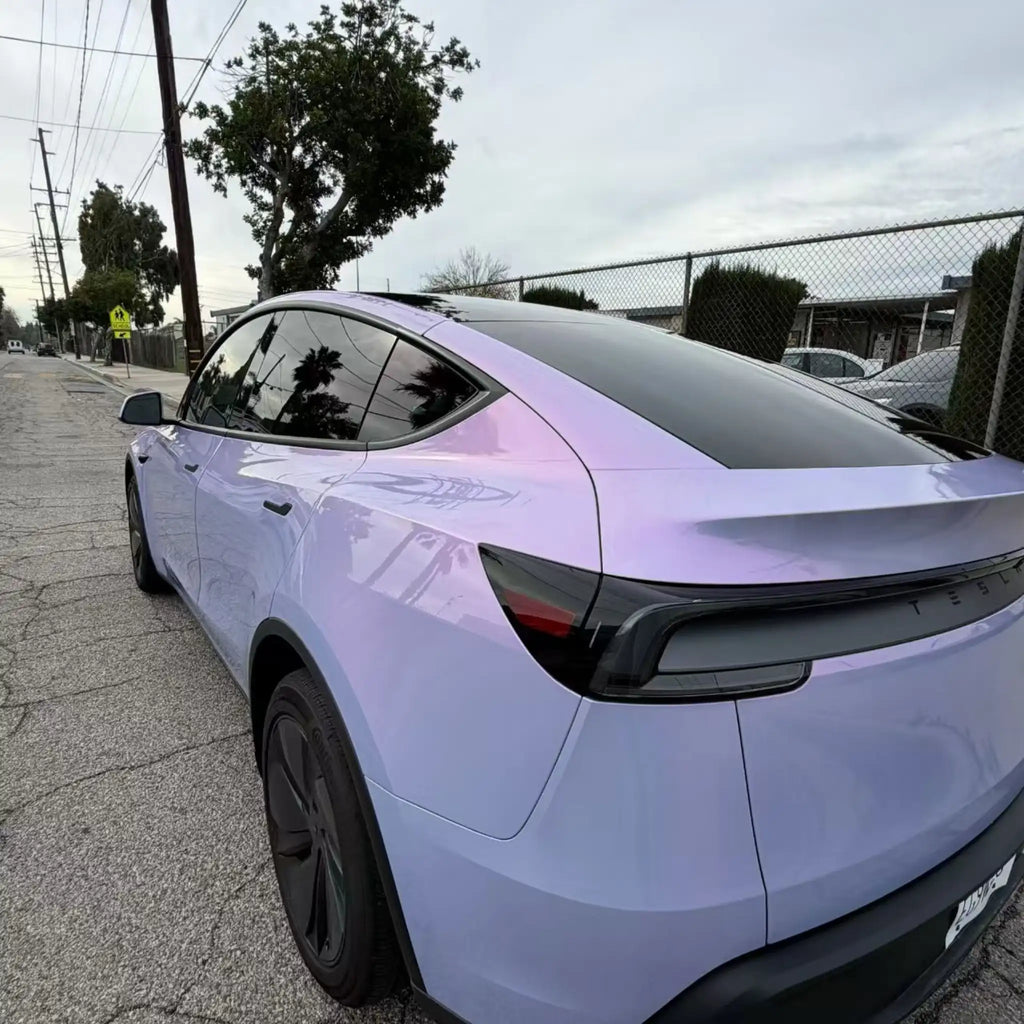 Detailed shot of Color Shift Pearl Blue Pink film on Tesla Model Y rear-left panel - Kaleido