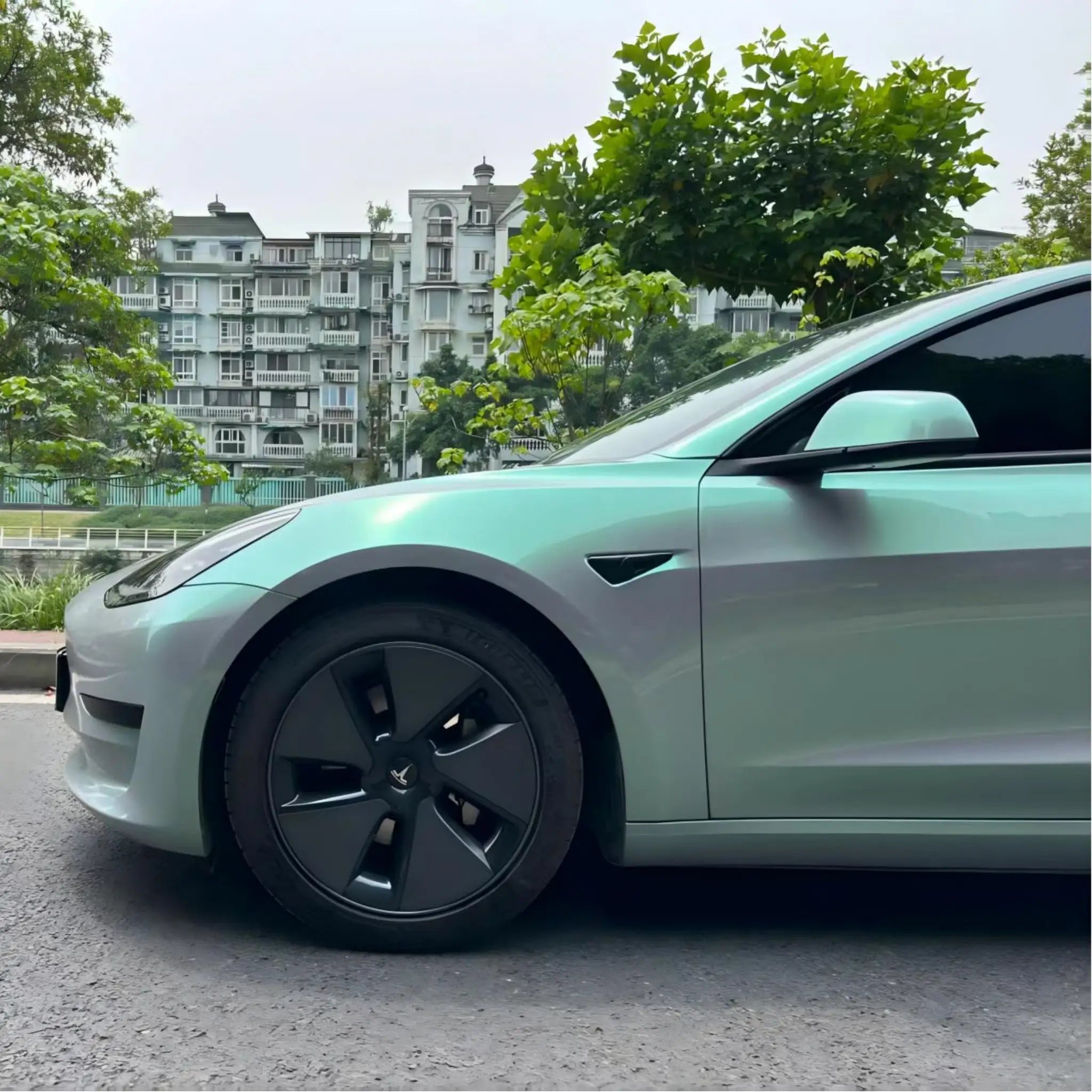 Close-up of Phantom Moss wrap on Tesla Model 3 front-left - color shift detail - Kaleido