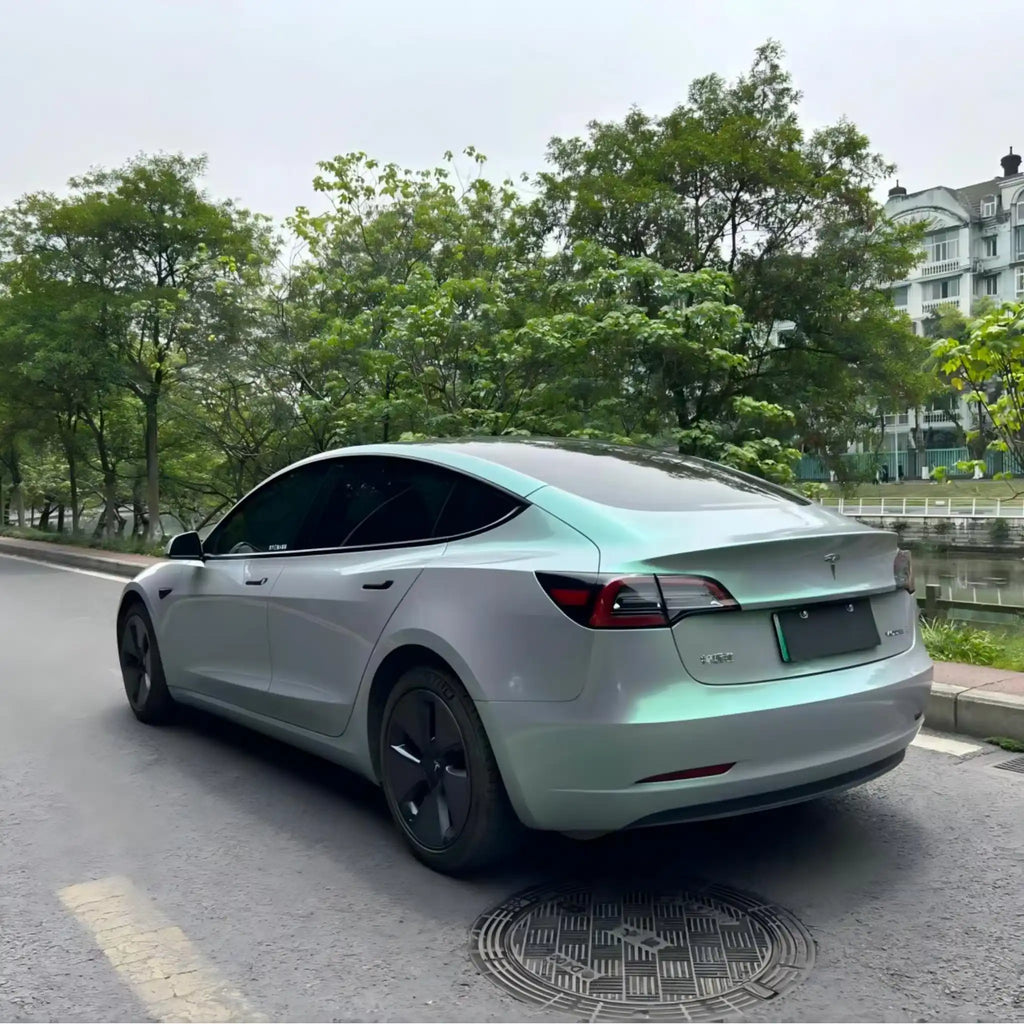 Phantom Moss vinyl wrap on Tesla Model 3 - rear-left angle showing chameleon finish - Kaleido