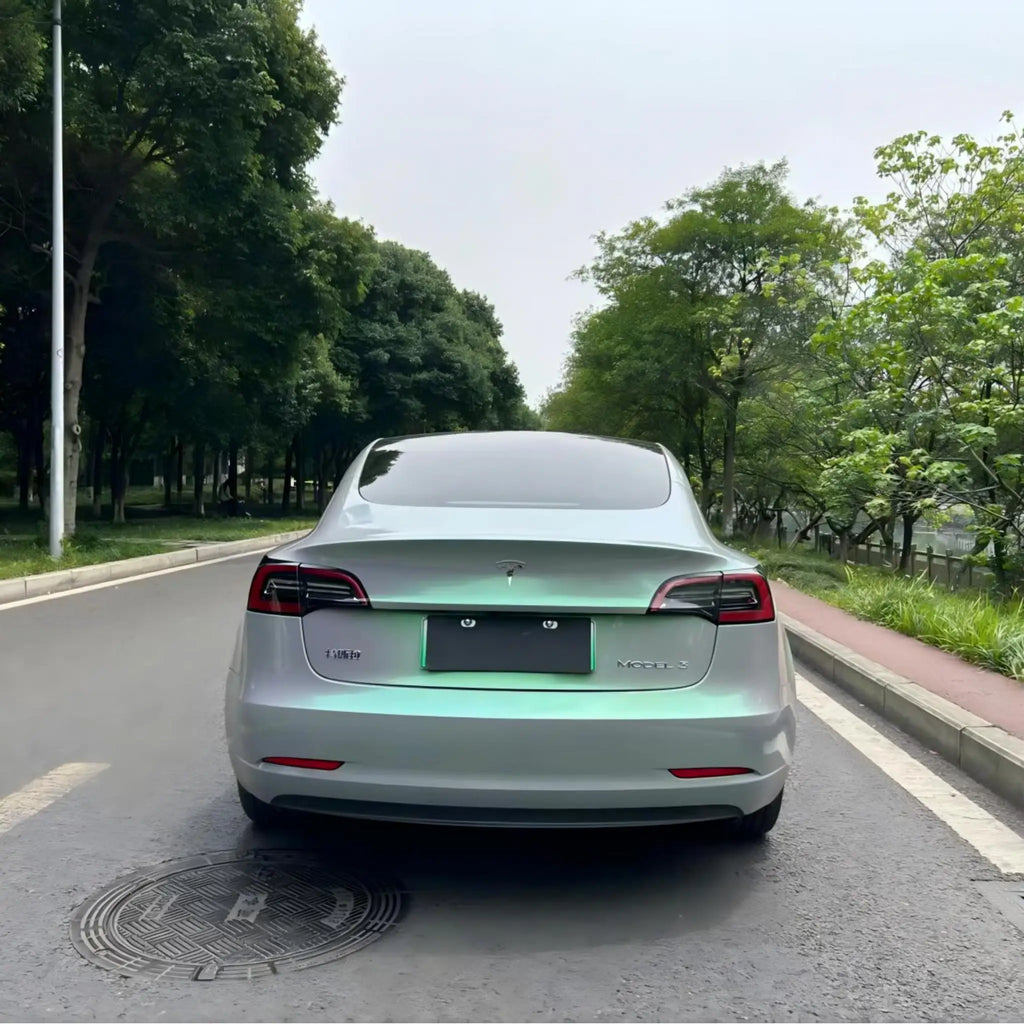 Rear view of Phantom Moss color shift wrap on Tesla Model 3 - grey to green effect - Kaleido