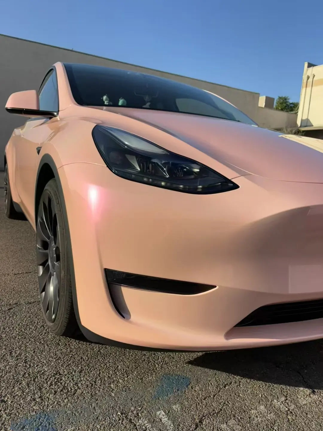 Close-up of Color Shift Pink Purple vinyl on Tesla Model Y front-right corner - Kaleido
