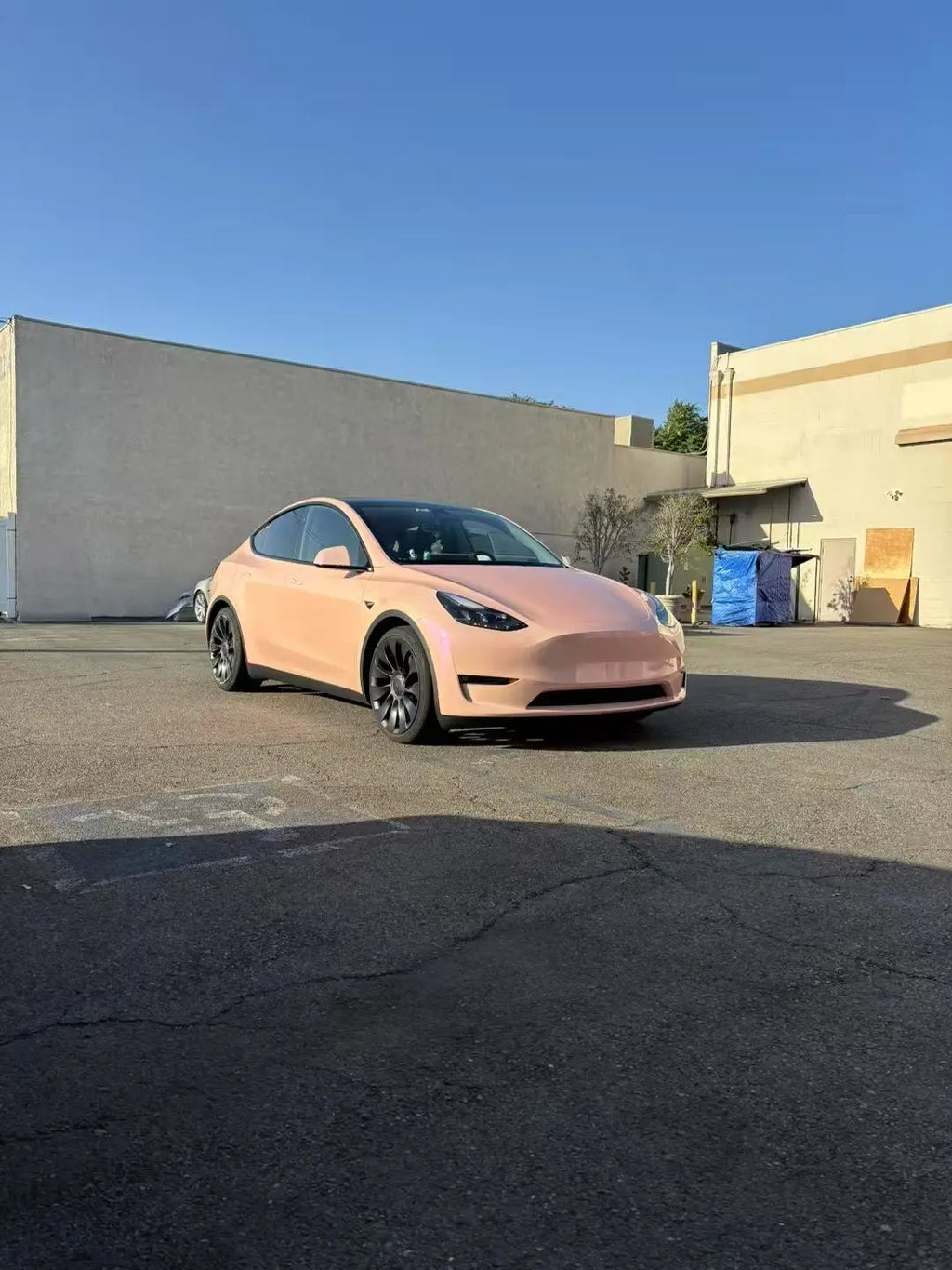 Tesla Model Y in Color Shift Pink Purple vinyl wrap - wide front-right view showing pink to purple transition - Kaleido