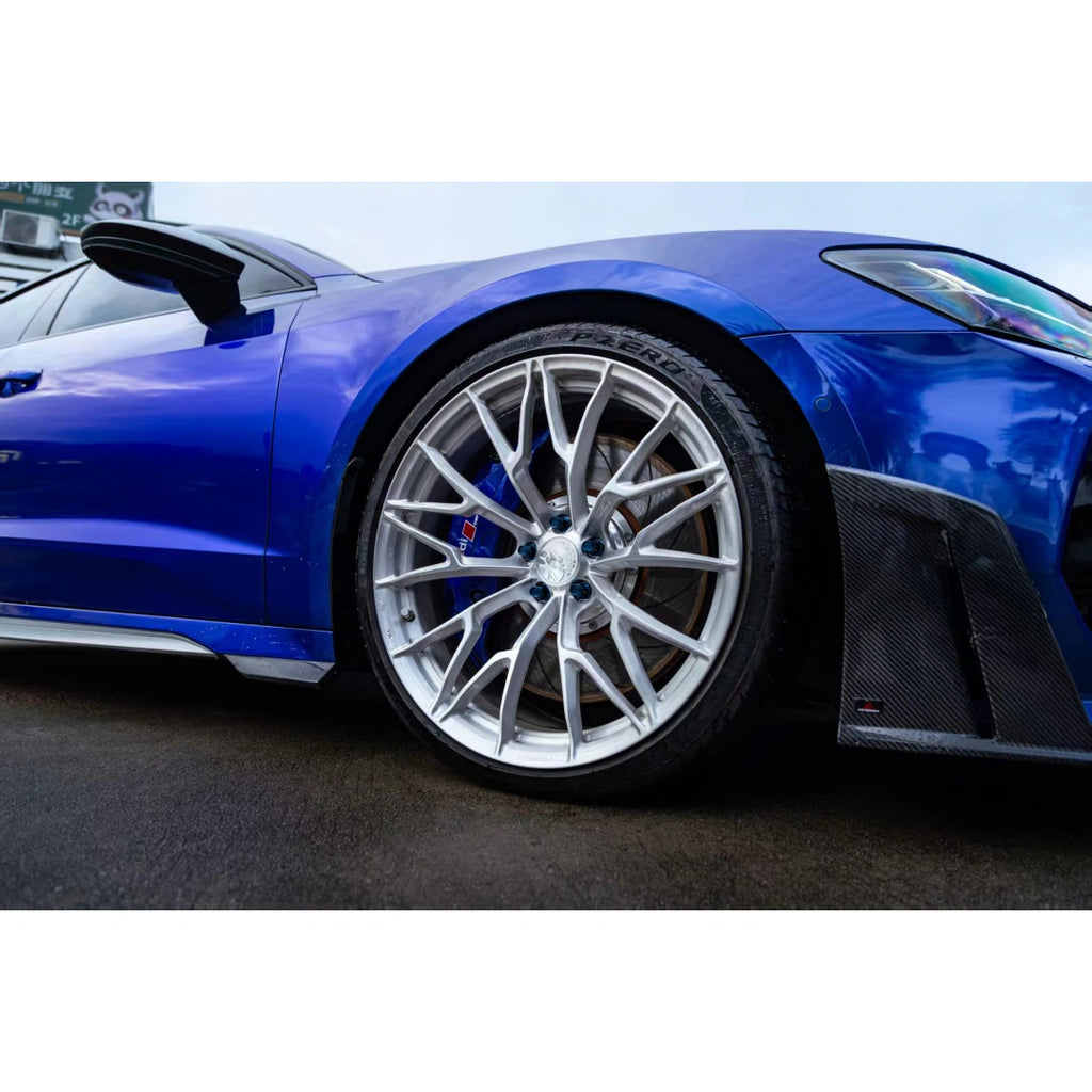 Detailed view of the Deep Blueberry Metallic finish on the Audi RS7's front wheel and brake caliper - Kaleido