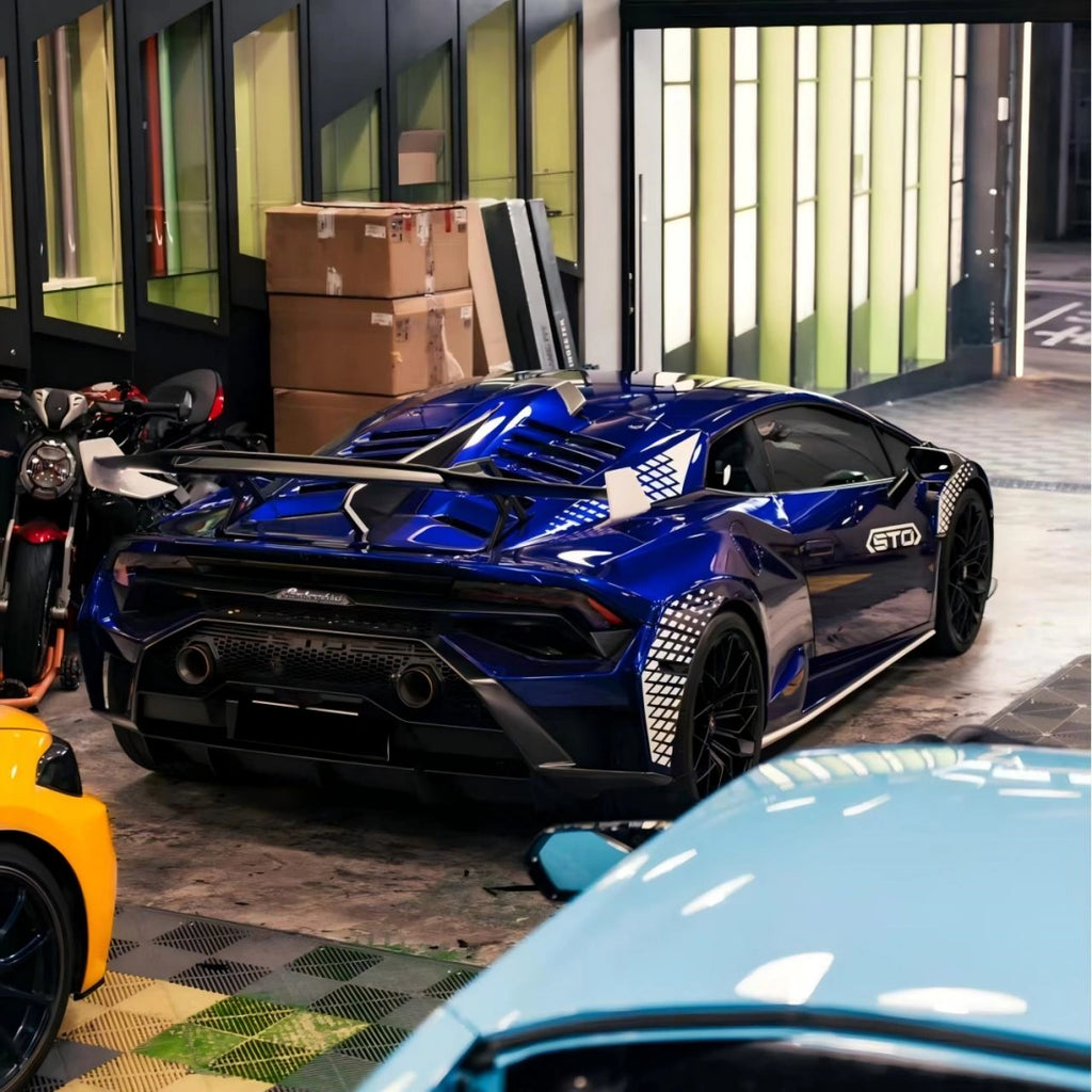 Deep Blueberry Metallic vinyl on the rear quarter panel of a Lamborghini Huracán STO, emphasizing the wide fenders and aerodynamic shape - Kaleido