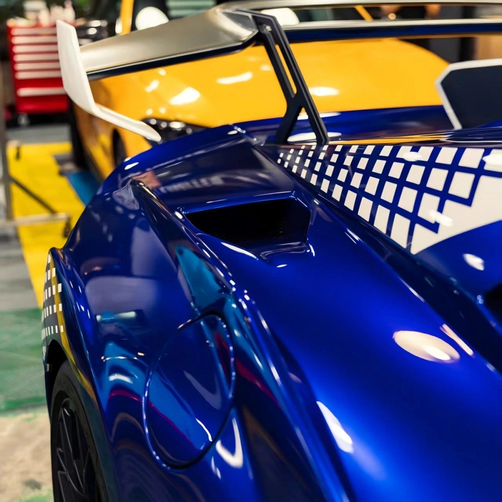 Rear three-quarter view of a Deep Blueberry Metallic wrapped Lamborghini Huracán STO, showing the iconic rear wing and side vents[citation:2] - Kaleido