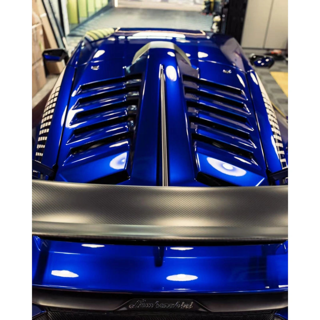 Rear view of a Lamborghini Huracán STO with Deep Blueberry Metallic wrap, featuring the large rear wing and dual exhaust[citation:1] - Kaleido