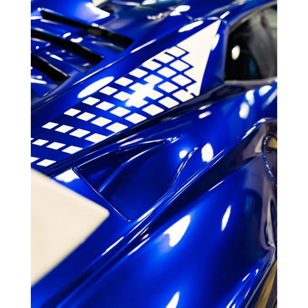Close-up side profile of a Lamborghini Huracán STO in Deep Blueberry Metallic, highlighting the low stance and sleek lines[citation:1] - Kaleido