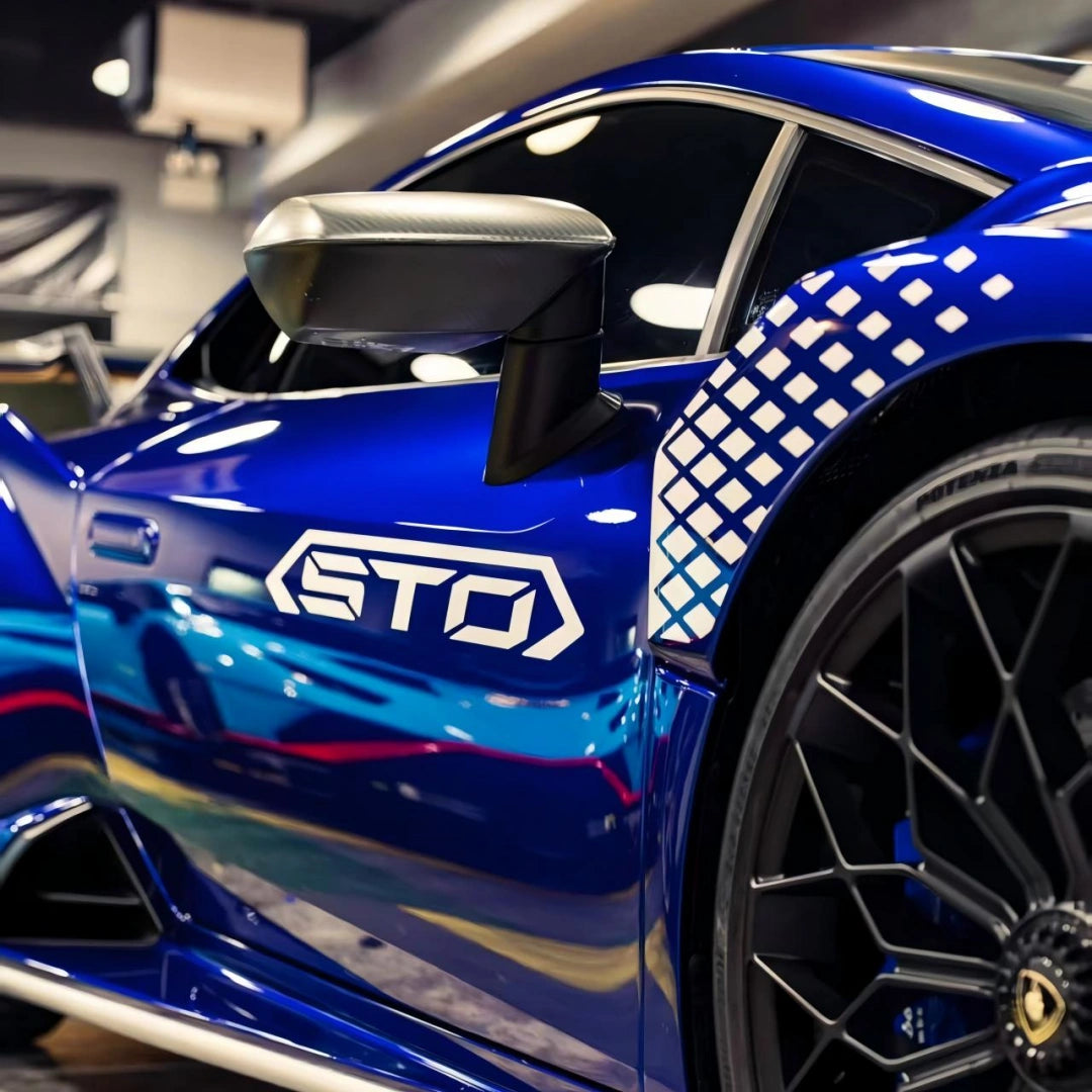 Detailed shot of the Deep Blueberry Metallic film on the Lamborghini Huracán STO's side air vent and 'STO' logo[citation:2] - Kaleido