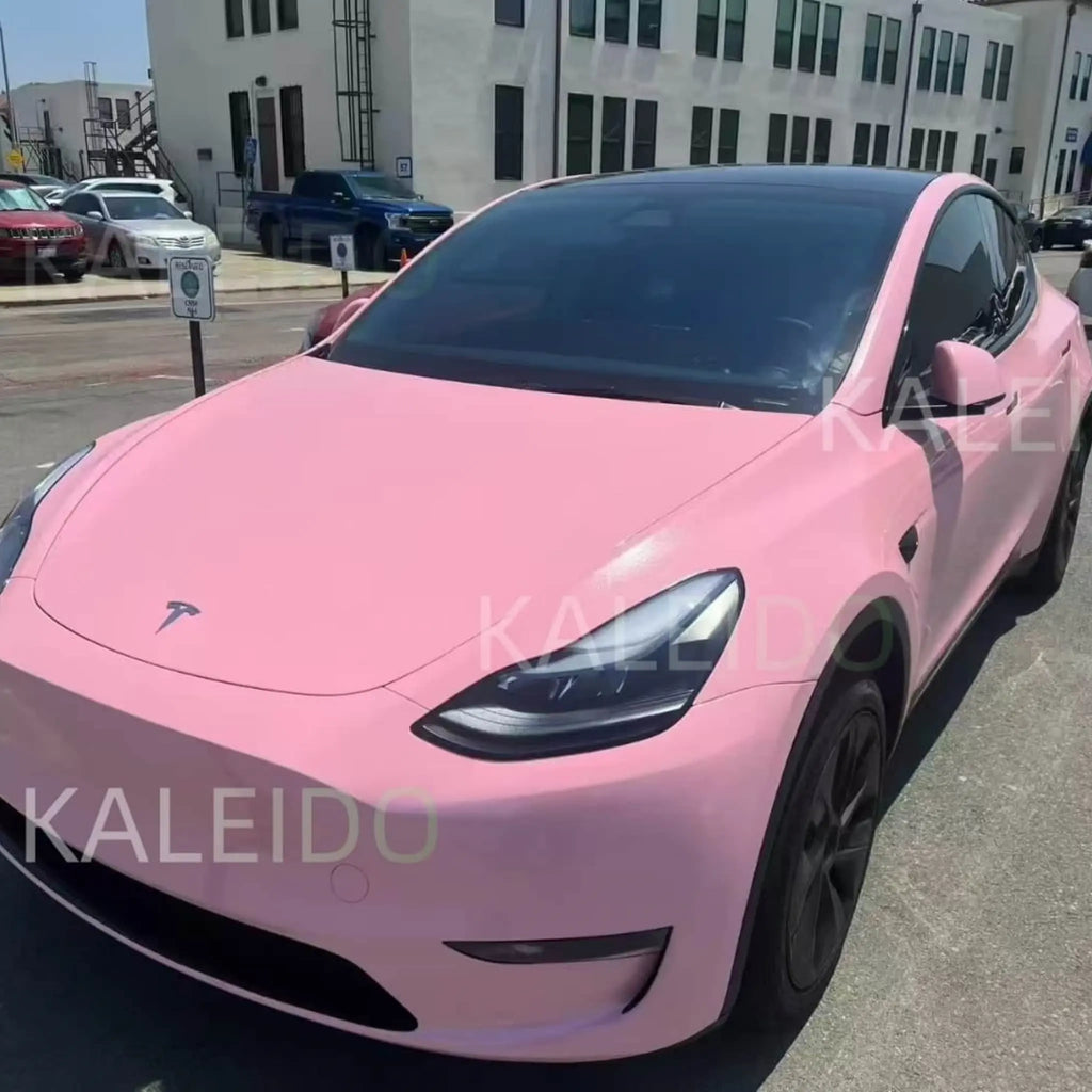 Diamond Iridescent Rouge Pink vinyl wrap on Tesla Model Y - front-left view showing soft pink pearl finish - Kaleido